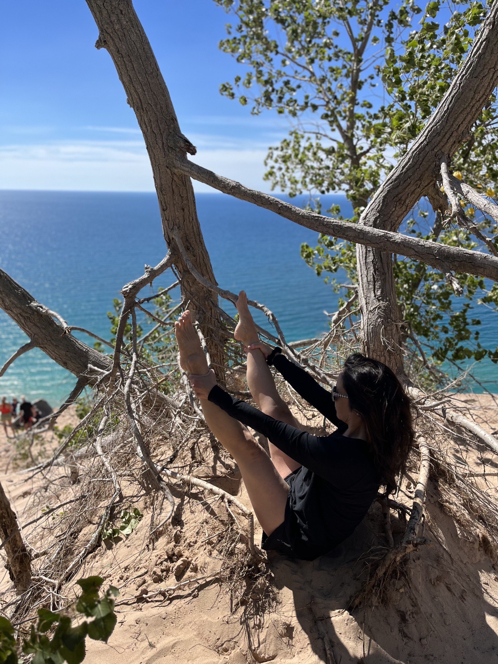 Annie stretching outdoors overlooking Lake Michigan